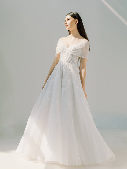 Woman wearing a white wedding dress against a light gray background