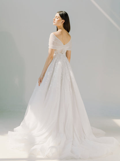 Woman wearing a white wedding dress against a light gray background