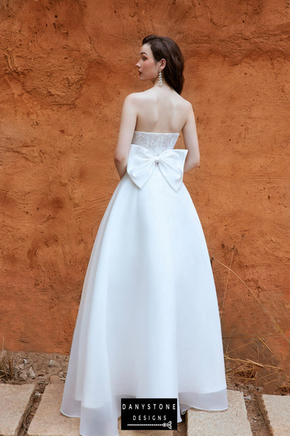 Back view of the Danystone Designs 2-in-1 wedding dress, showcasing the elegant bow and detachable skirt.