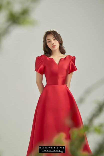 Elegant red dress with fairy wing sleeves model posing indoors