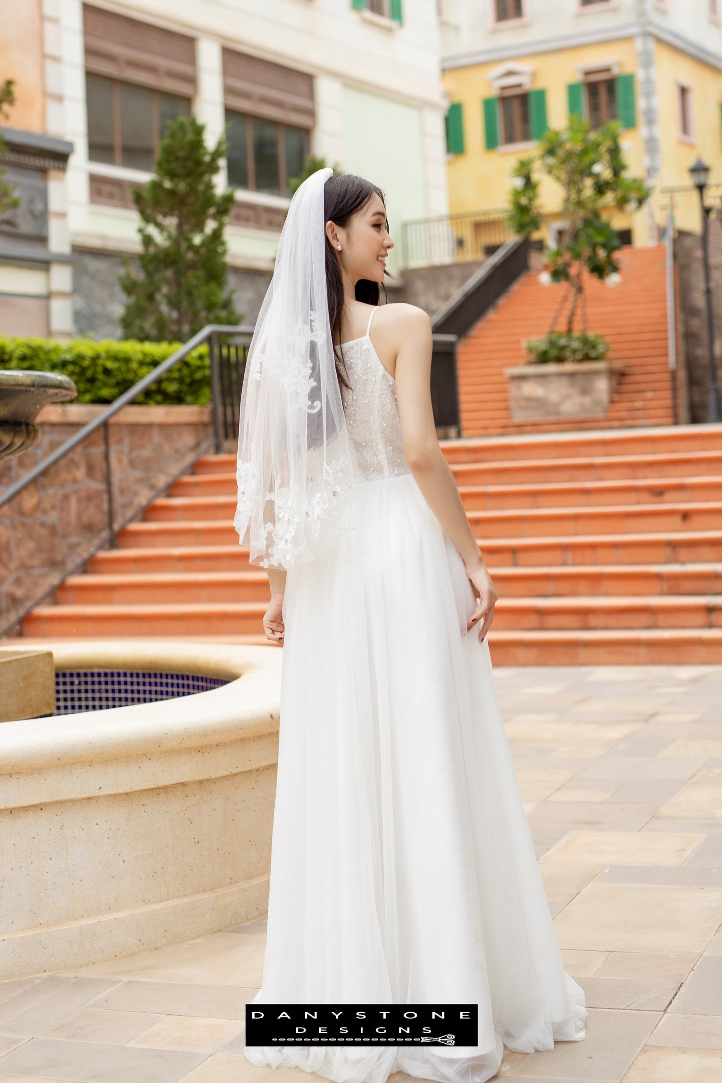 Image 5: Close-up of a bride in a camisole wedding dress with mesh beads, highlighting the beaded bodice.