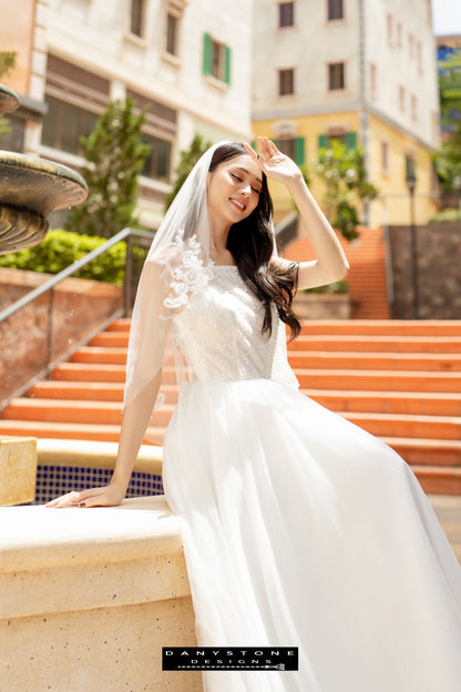 Image 6: Back view of a bride in a camisole wedding dress with mesh beads, showing the flowing skirt.