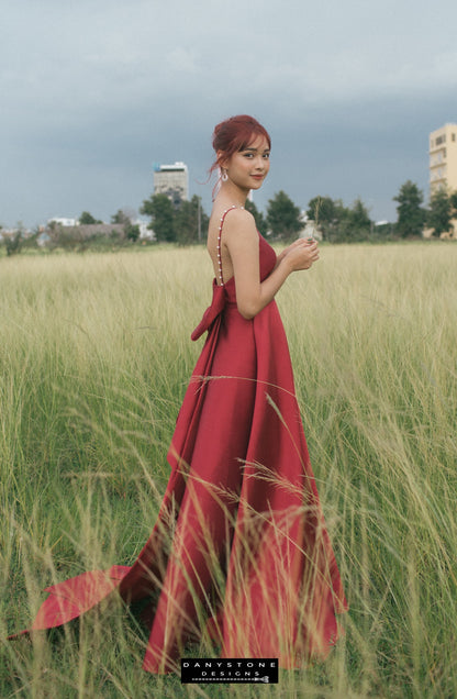 Elegant red evening dress with pearl straps and a large bow designed by Danystone Designs