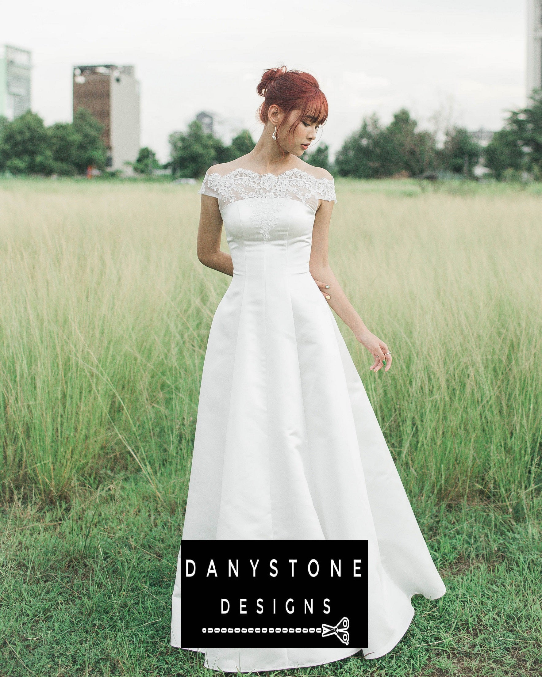 Bride wearing a 7-piece satin wedding dress with 3D flower lace chest standing in a grassy field