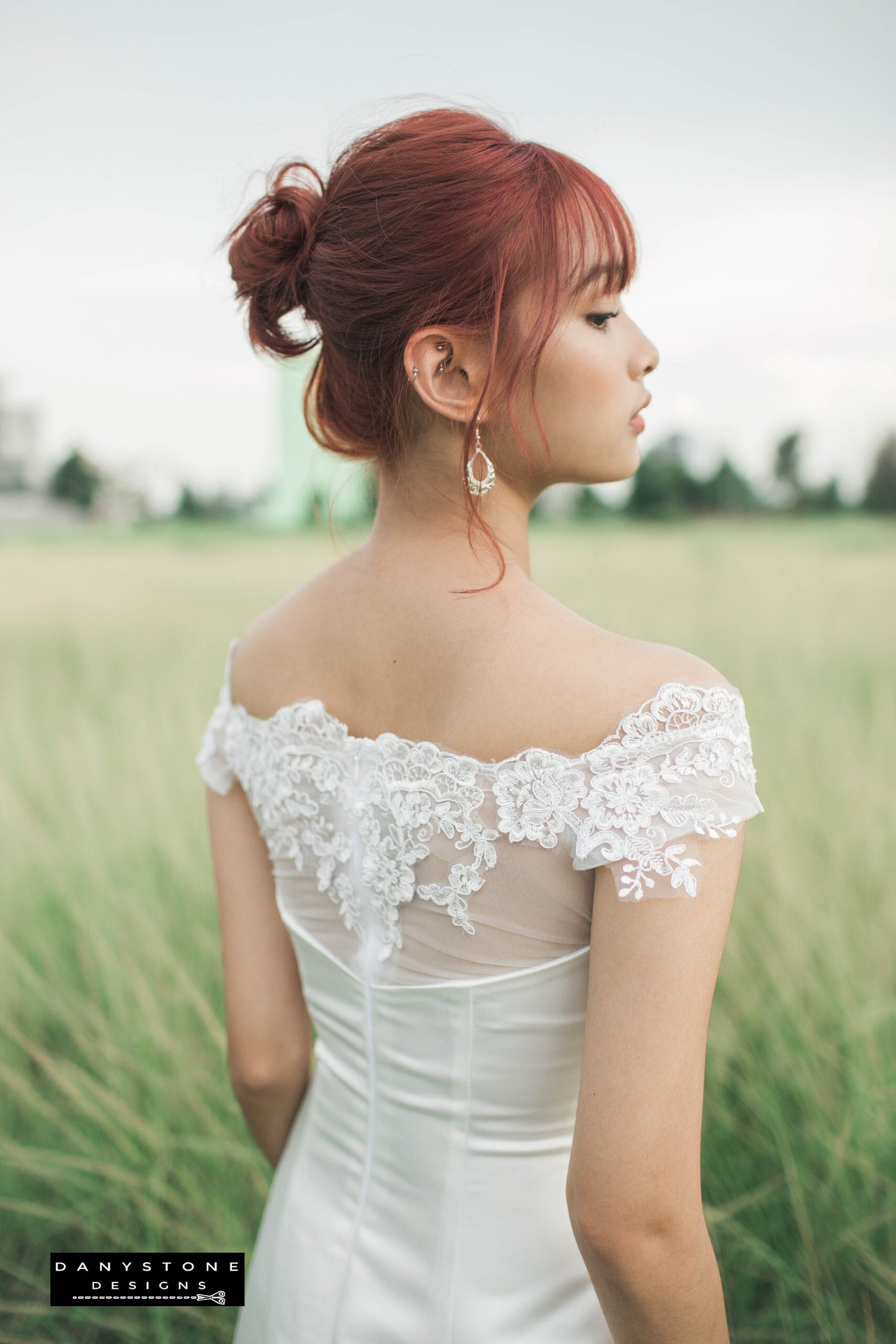 Back view of 7-piece satin wedding dress with 3D flower lace chest showcasing off-shoulder neckline