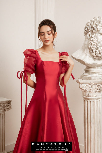 Front view of a red wedding dress with silk chiffon sleeves model posing indoors