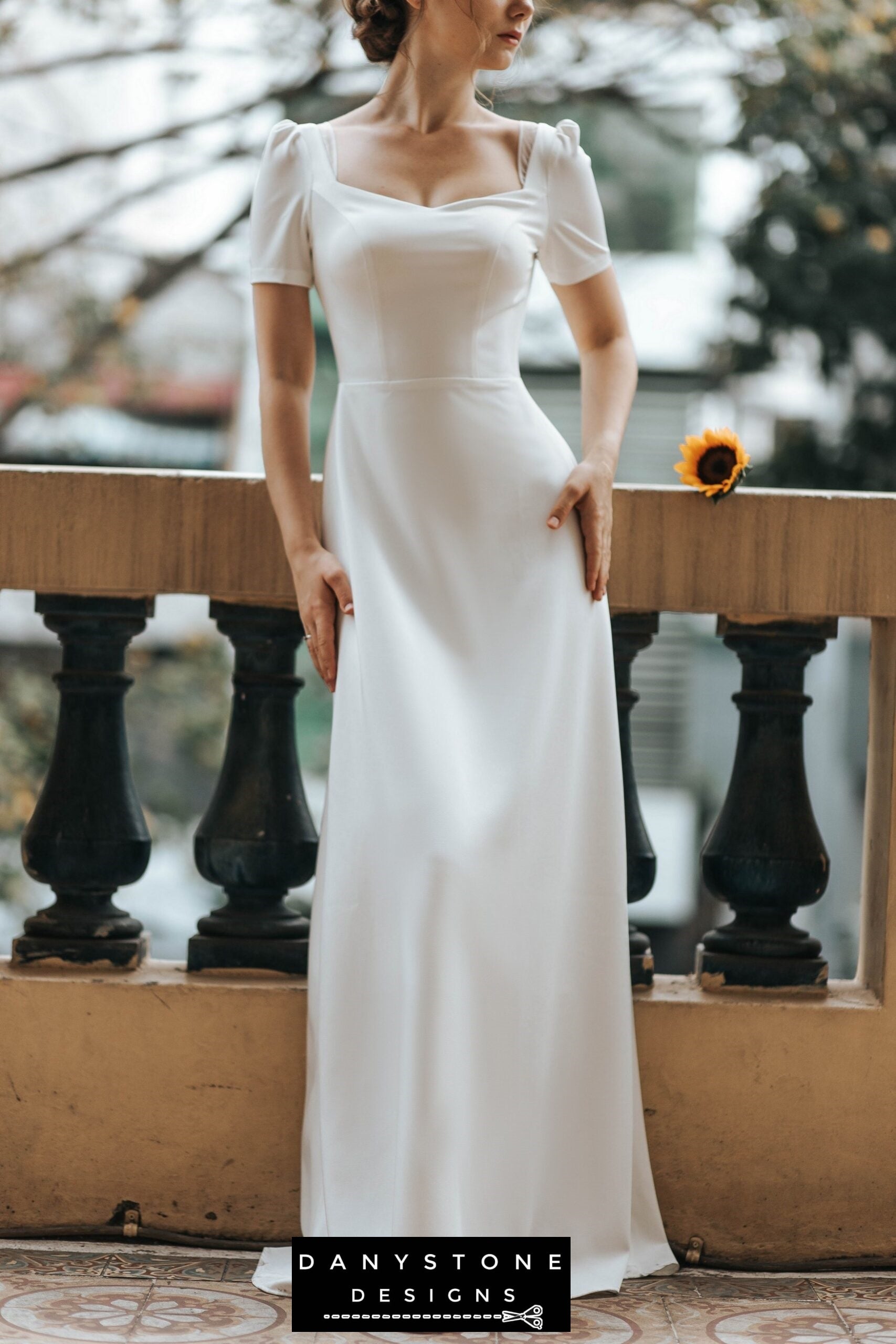 Sophisticated bride in backless wedding dress with square neckline and short sleeves – Danystone Designs