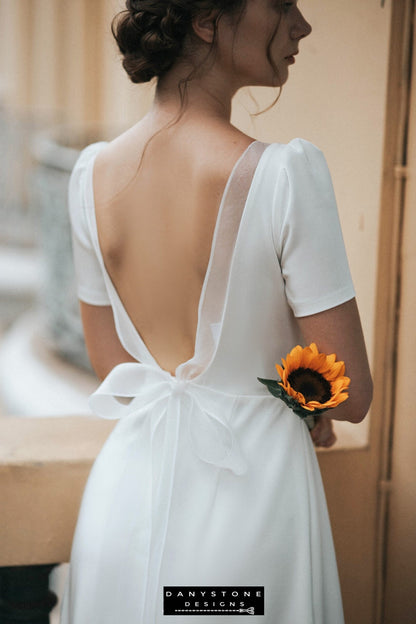 Close-up of bride in backless wedding dress with square neckline and short sleeves – Danystone Designs