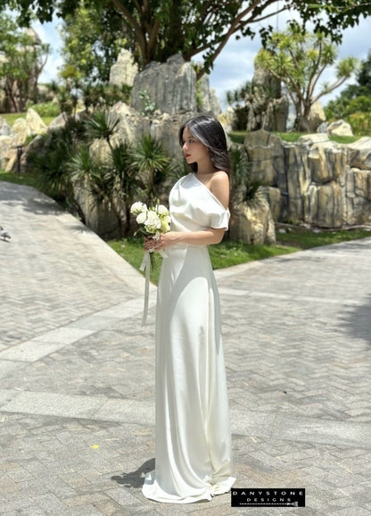 Model wearing an off-the-shoulder satin wedding dress, side view.