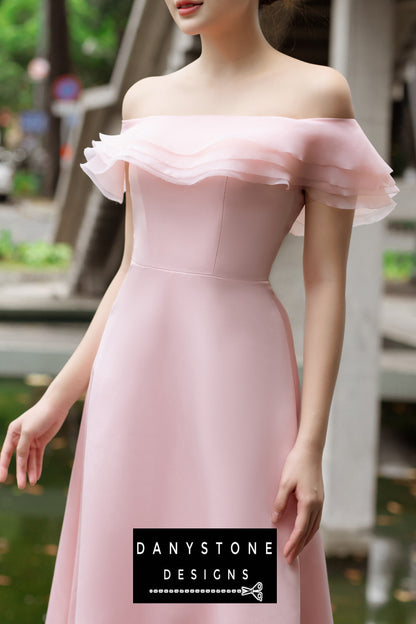 Model wearing an elegant pink off-shoulder midi dress with layered ruffles