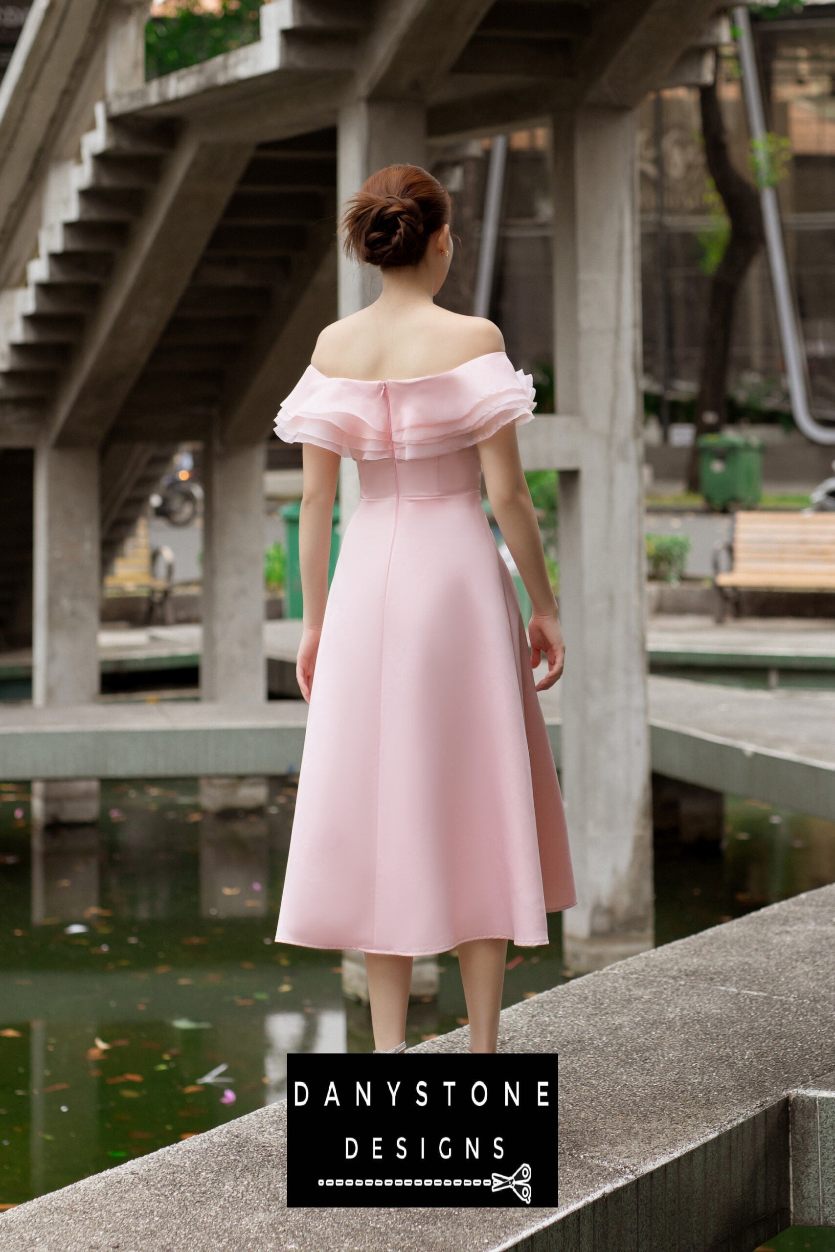 Woman in a pink off-shoulder dress with four layers of satin and silk chiffon