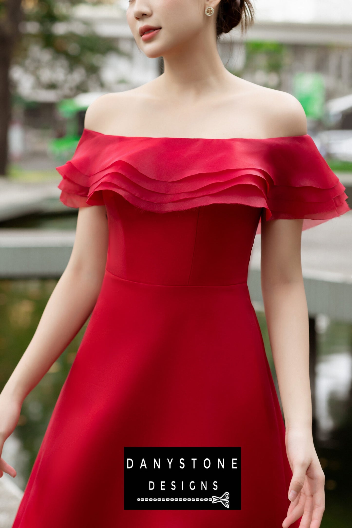 Woman in a red off-shoulder dress with four layers of satin and silk chiffon