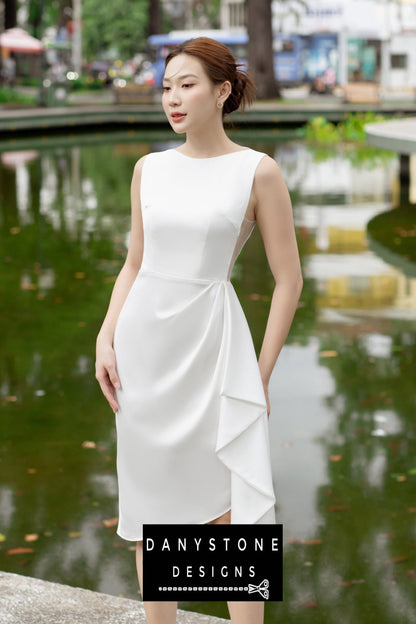 Side view of a woman wearing a short boat neck dress with pleated waist, featuring sheer side panels.