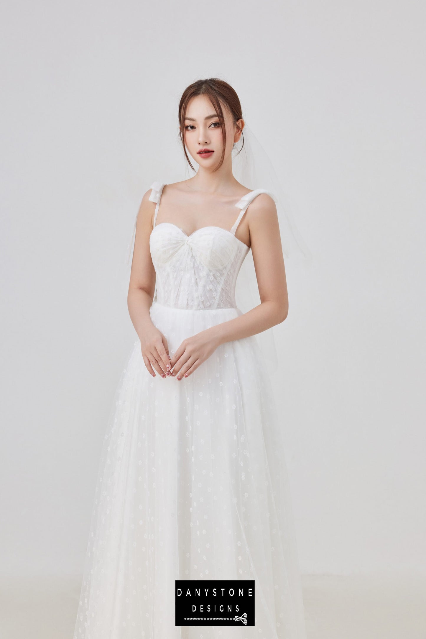 Make a stunning statement on your special day with this elegant tulle corset wedding dress, featuring a sweetheart neckline and delicate bow straps. The ethereal tulle skirt adds a touch of romantic elegance.