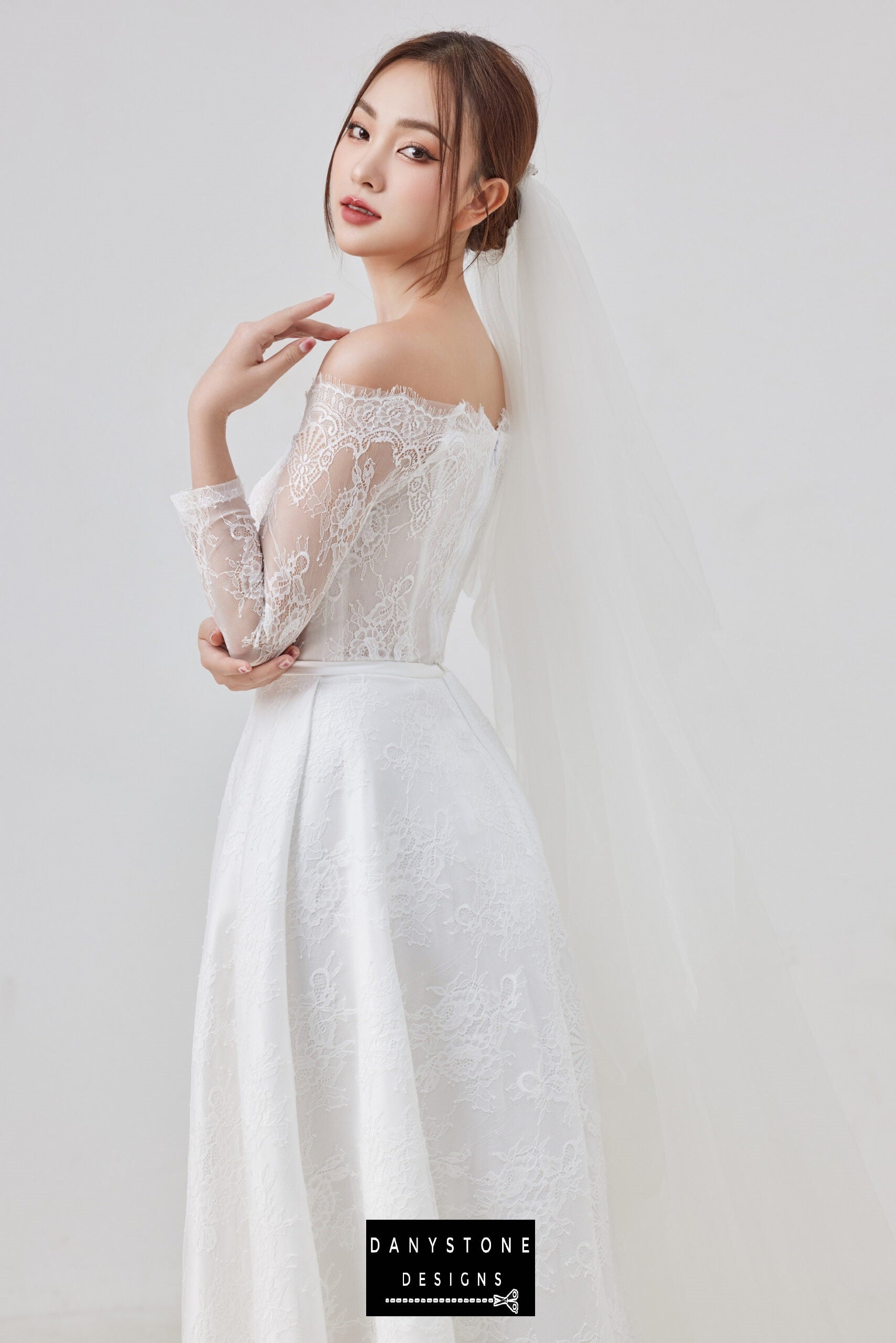 A back view of the thin lace dress highlighting the delicate lace fabric and flowing skirt.