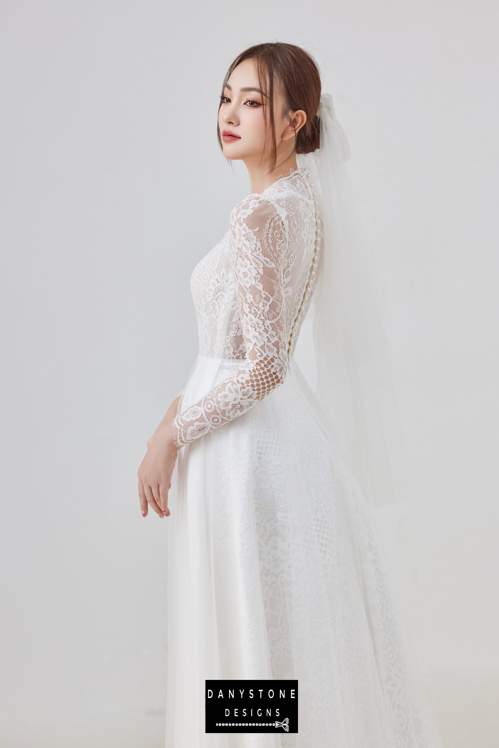 Model showcasing the side view of the elegant queen collar lace dress with mesh parts.