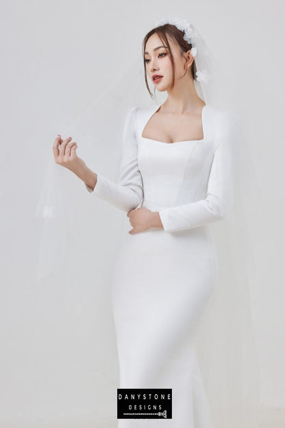 Sophisticated bride in long-sleeve wedding dress with veil and square neckline – Danystone Designs