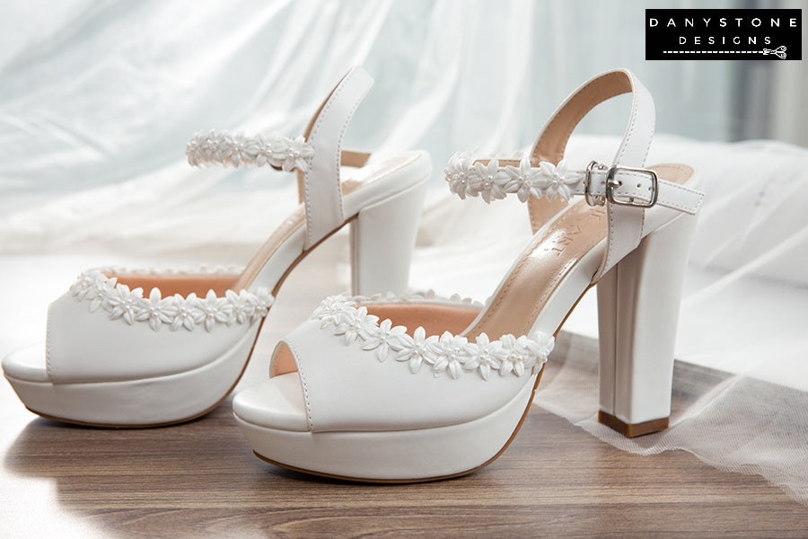 Side view of matte leather platform heels with hand-woven floral design, showcasing the elegant straps.